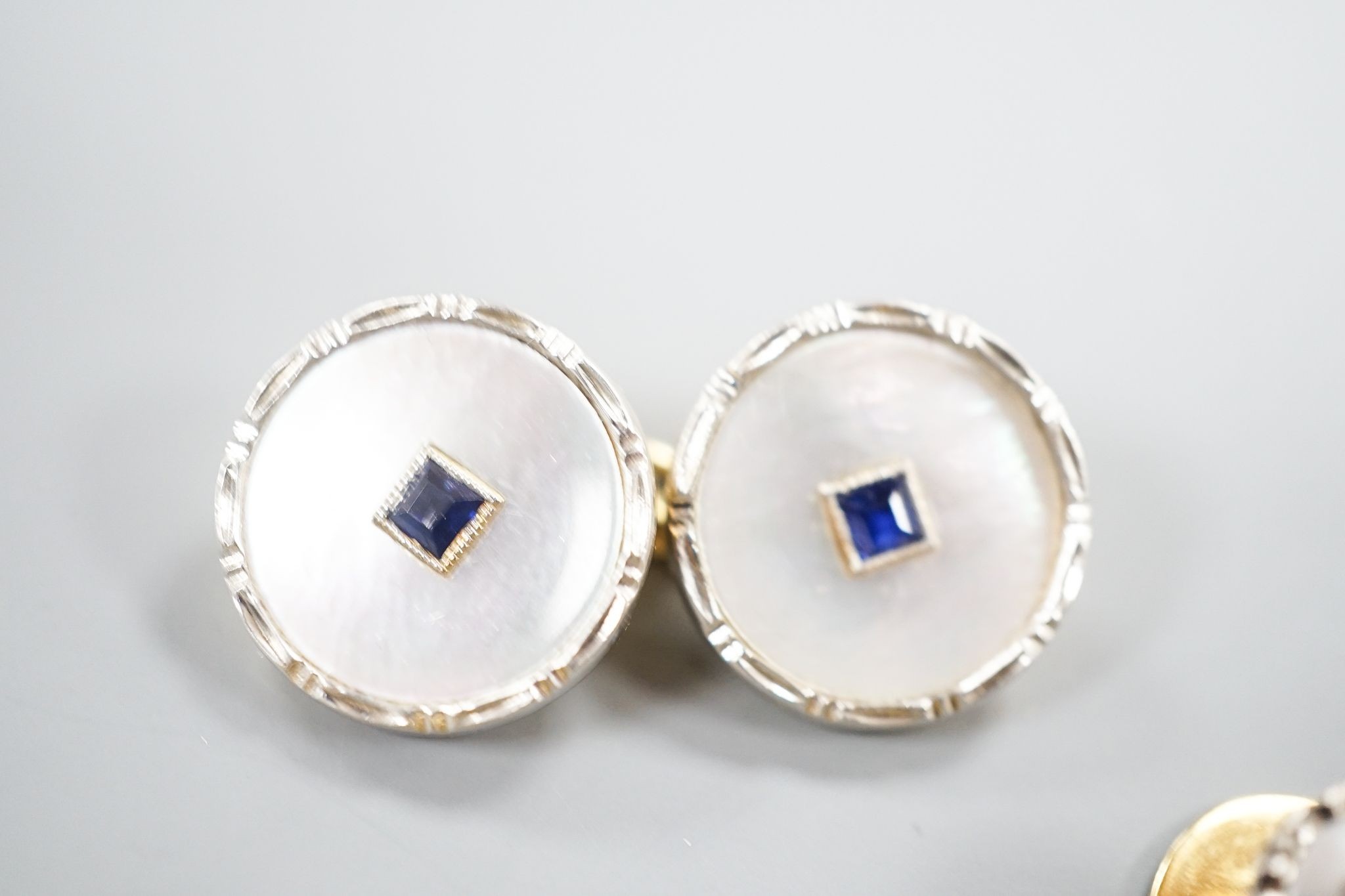 A pair of 18ct, mother of pearl and sapphire set circular cufflinks, 13mm and a pair of matching dress studs, gross weight 8.6 grams.